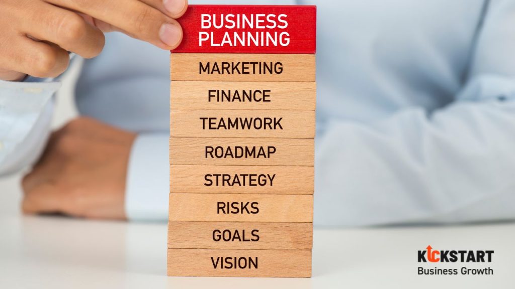 Entrepreneur developing a UK startup business plan with clear goals, market research, financial projections, and risk analysis to secure funding and drive long-term success — with guidance from Kickstart Business Growth
